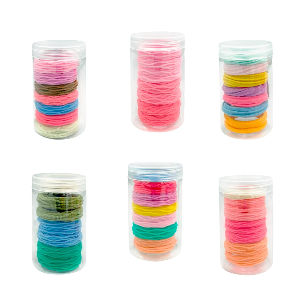 Bote transparente con 7 donas ligas de colores con efecto corrugado para el cabello / 020036